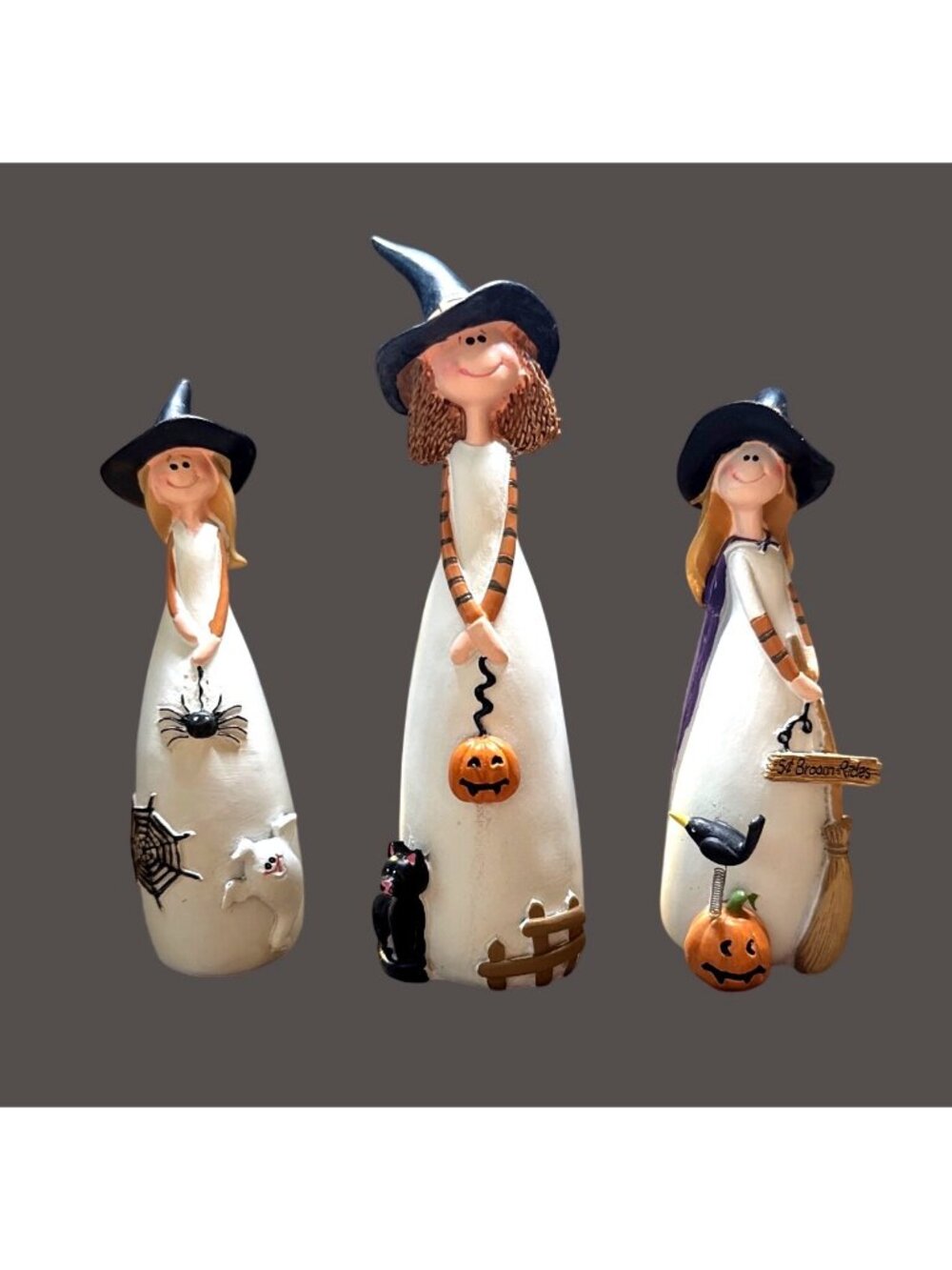 Charming set features whimsical white witch figurines wearing pointed hats
